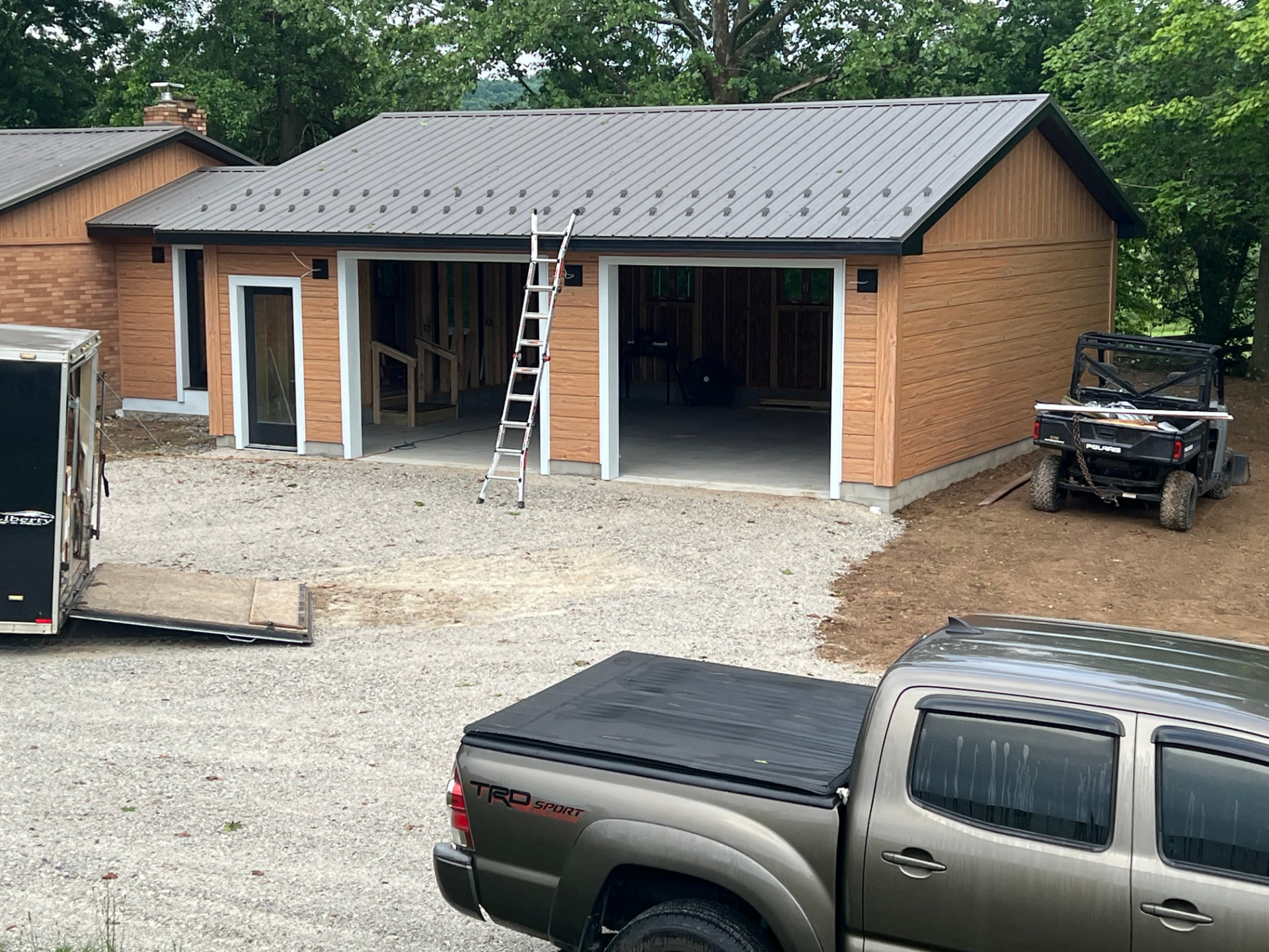 Completed Cateye garage project with metal roof and wood siding